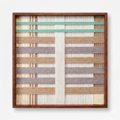 Frontal studio shot of the Sleeping Flora hand-woven wool wall art featuring geometric pastel patterns in a wooden frame against a clean white background.
