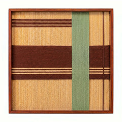 Frontal studio shot of the Amber Pine hand-woven textile wall art featuring tan and brown horizontal stripes with a vertical green stripe in a wooden frame against a clean white background.