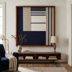 Striking square hand-woven wool tapestry positioned perfectly above a low wooden console table in a modern, serene living space with blue accents.