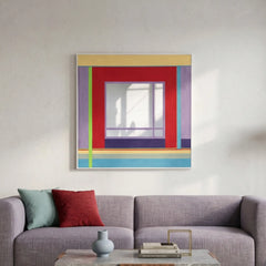 Large hand-woven wool wall art featuring red, purple, and blue geometric patterns hanging above a modern lavender sofa in a bright room.