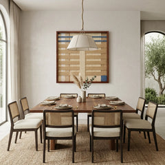 Modern beige and blue textured fiber wall art styled in a contemporary dining room above a large wooden table with cane dining chairs.