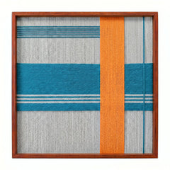 Frontal studio shot of the Breeze of Capri hand-woven textile wall art featuring a teal horizontal stripe and an orange vertical stripe in a wooden frame against a clean white background.