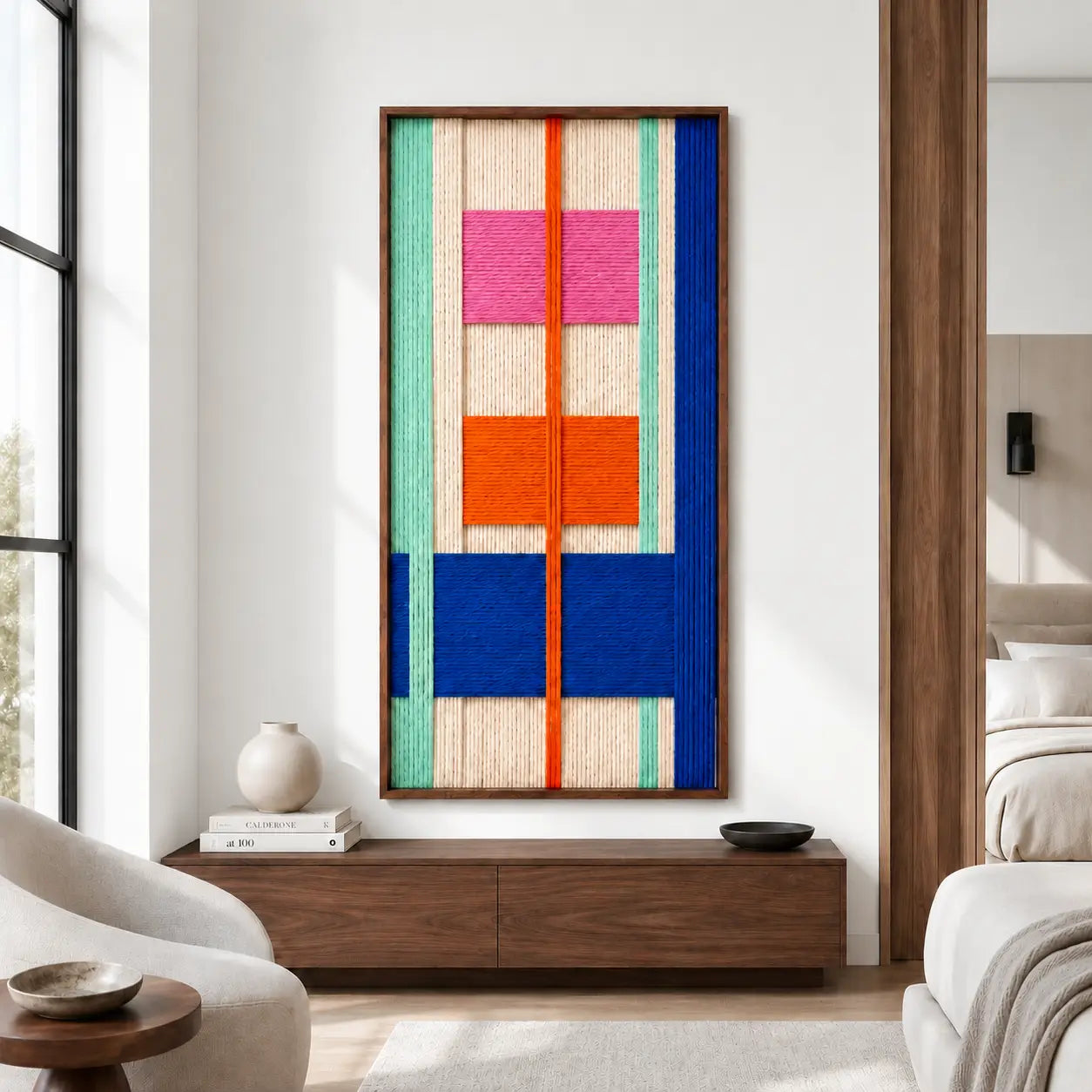 Contemporary living room interior styling featuring the geometric textile art mounted on a warm neutral wall above a modern low wooden media console.