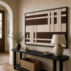 Striking Cocoa Pillars framed wall art styled in a bright entryway hallway hanging above a sleek black console table.