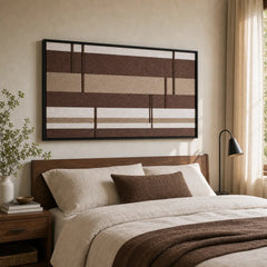A beautiful hand-woven wool tapestry displayed beautifully above a styled bed with brown accents in a warm, cozy bedroom.