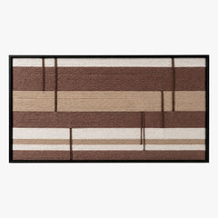 Frontal studio shot of the Cocoa Strata hand-woven wool wall art featuring brown and beige horizontal stripes in a black frame.