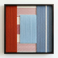 Frontal studio shot of the Cold Fire hand-woven wool wall art in a square black frame against a clean white background.