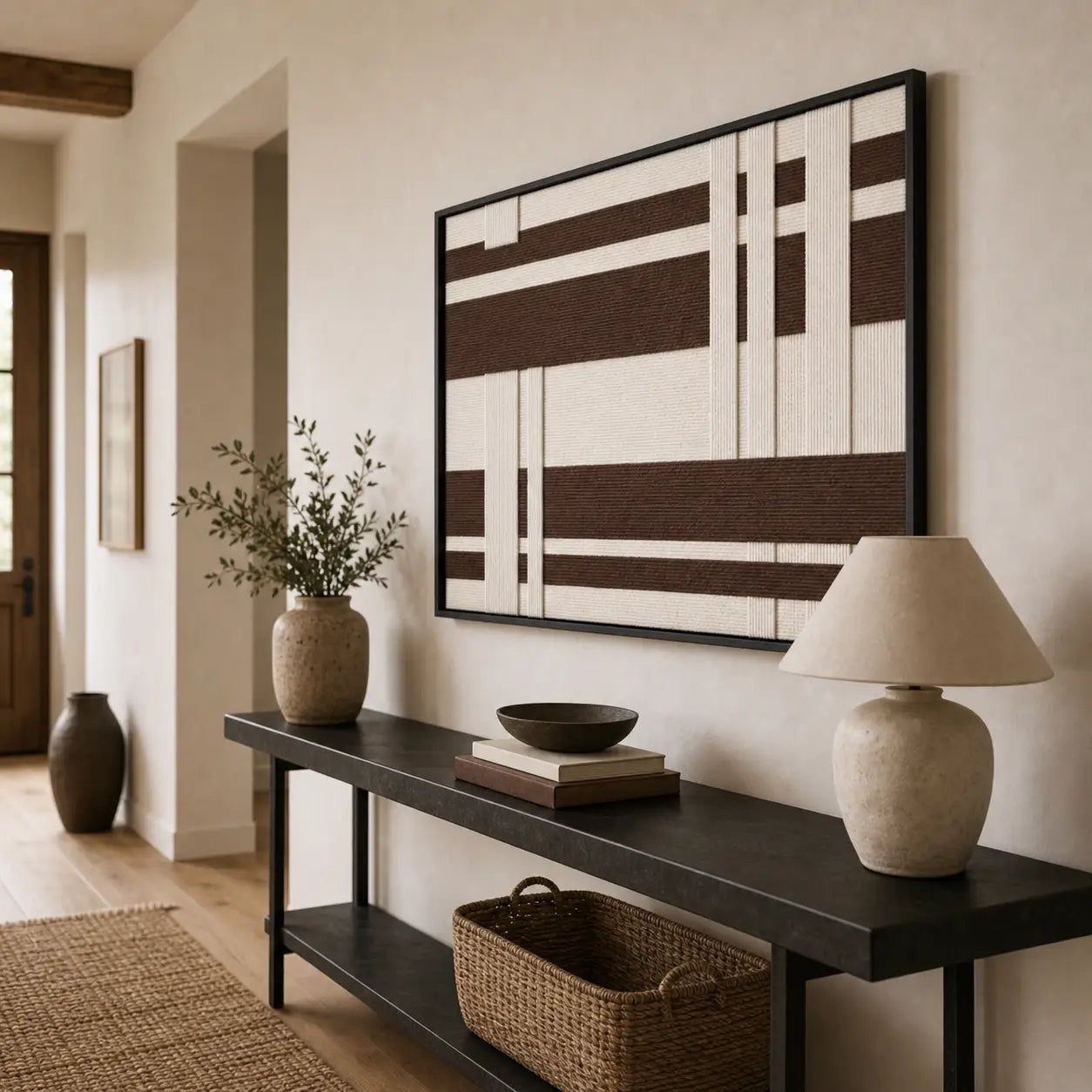 Striking Earthen Bands framed wall art styled in a bright entryway hallway, hanging elegantly above a sleek black console table.