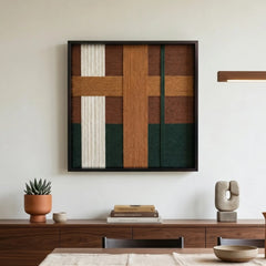 Framed textured fiber art displayed in a sunlit living room above a low walnut sideboard with minimalist terracotta pottery.