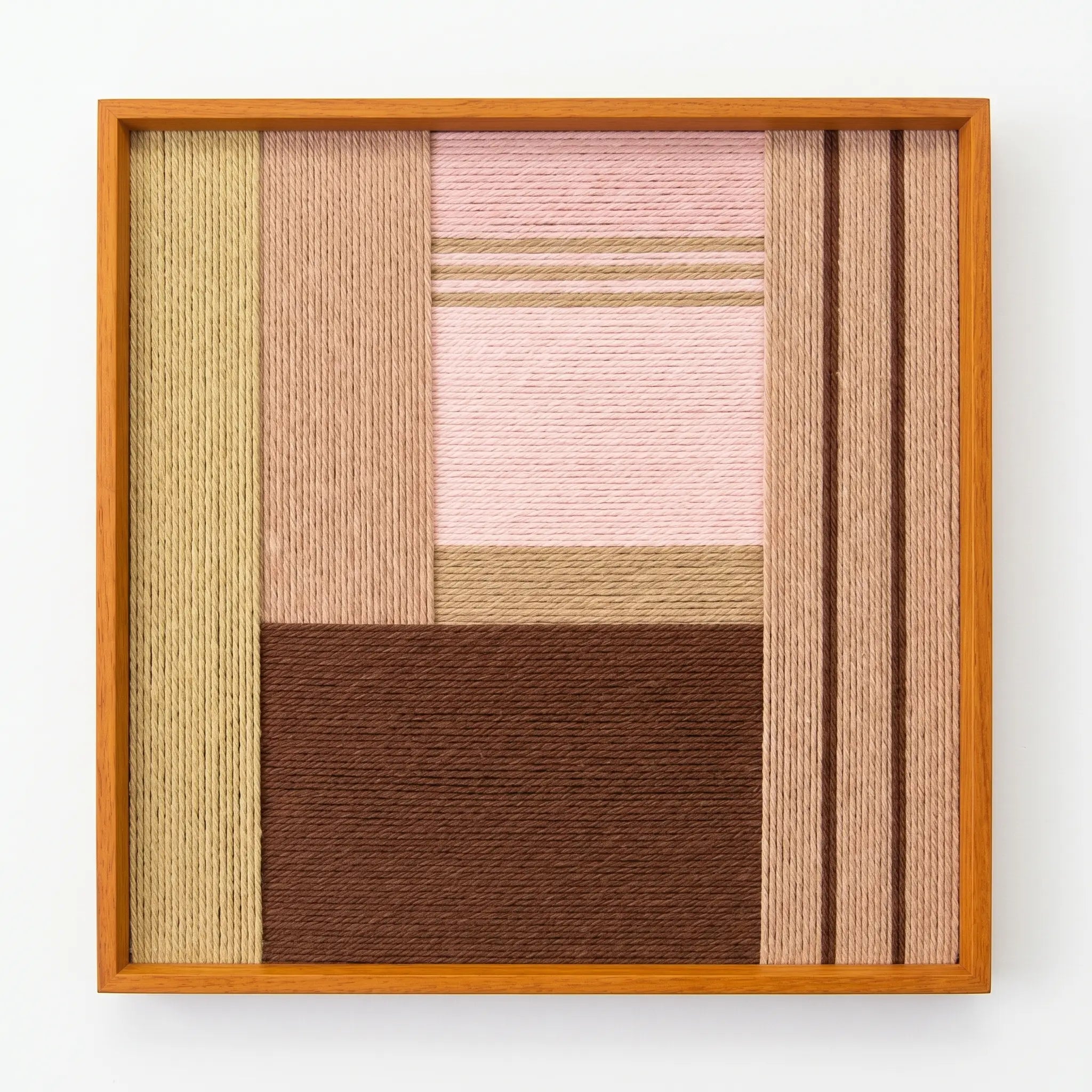 Frontal studio shot of Folded Dialogue hand-woven wool wall art featuring dusty pink and espresso geometric blocks in an oak frame.