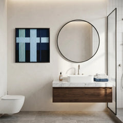 Framed textured wool wall art displayed in a luxury bathroom above a floating walnut vanity and large circular mirror.