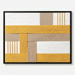 Frontal studio shot of the Golden Interval hand-woven wool wall art featuring yellow and beige geometric patterns in a black frame.