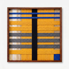 Frontal studio shot of the Golden Monsoon hand-woven wool wall art featuring geometric yellow, grey, and black patterns in a wooden frame against a clean white background.