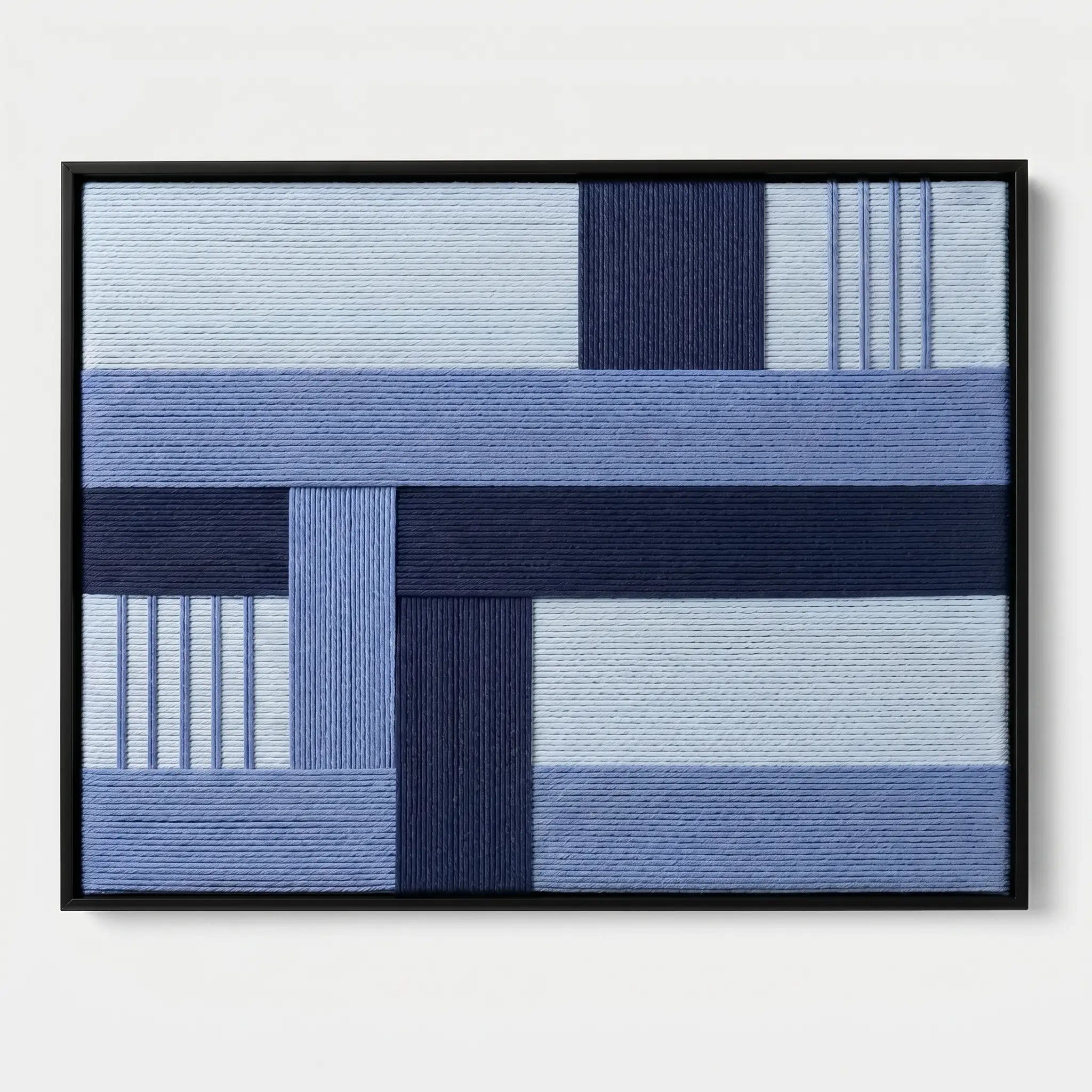 Frontal studio shot of the Nordic Tide hand-woven wool tapestry featuring blue geometric patterns in a black frame against a white background.