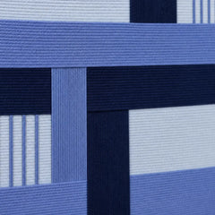 Detailed macro shot of the Nordic Tide hand-woven wool tapestry highlighting thick navy and light blue intersecting yarn textures.