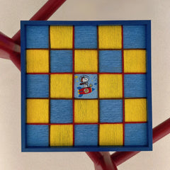 Close-up front view of the textured fiber wall art showing the yellow and blue hand-woven checkerboard pattern and a central Snoopy space patch.