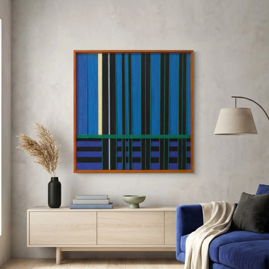 Square hand-woven wool wall art in a cherry wood frame featuring vertical stripes of cobalt blue and black with a green horizontal accent, hanging above a light oak sideboard.