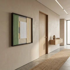 Perspective view of the Sun-Baked textured fiber art hanging in a minimalist modern hallway with a jute runner rug.