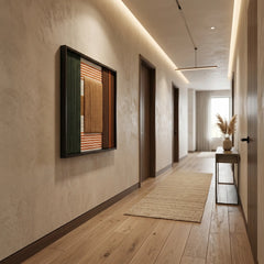 Perspective view of the Sylvan Glow fiber art hanging in a modern long hallway with warm recessed lighting and wood floors.