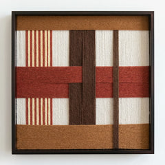 Professional studio shot of the Terracotta Script hand-woven wool wall art in a black frame against a clean white background.