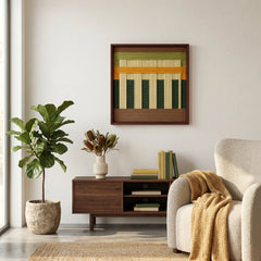 Modern wool wall decor styled in a cozy room corner above a small wooden unit, next to a fiddle leaf fig plant and armchair.