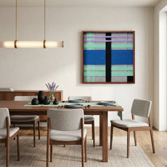 Vibrant geometric wool art piece creating a bold focal point in an open dining space with a wooden dining set and minimalist pendant light.