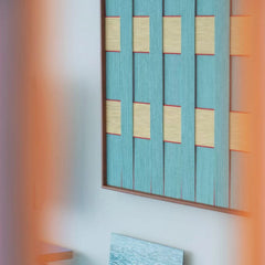 Close-up side view of the Afternoon Window hand-woven wool tapestry highlighting the thick vertical teal fibers and wooden frame depth.