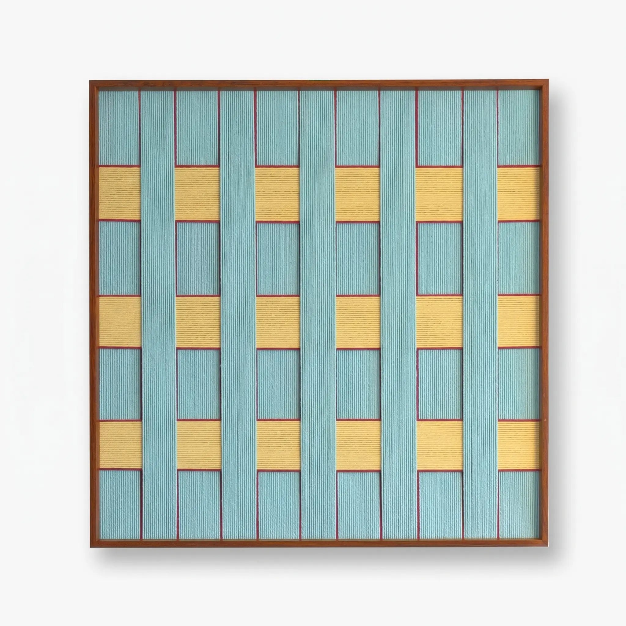Frontal studio shot of the Afternoon Window hand-woven textile wall art featuring light blue and yellow geometric patterns in a wooden frame against a clean white background.