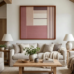 Beautiful framed hand-woven textile wall art styled elegantly in a bright living room, hanging above a comfortable beige sofa and matching light wood coffee table.