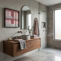 Modern hand-woven fiber art displayed in a bright bathroom setting above a walnut vanity with a vessel sink and stone counter.