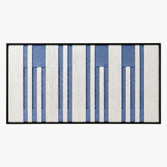 Frontal studio shot of the Blue Cadence hand-woven wool tapestry featuring vertical blue and white stripes in a black frame.