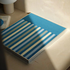 Blue Night yarn wall art flat lay view showing square form and uniform blue stripe weave, emphasizing balanced color transitions and stitch uniformity
