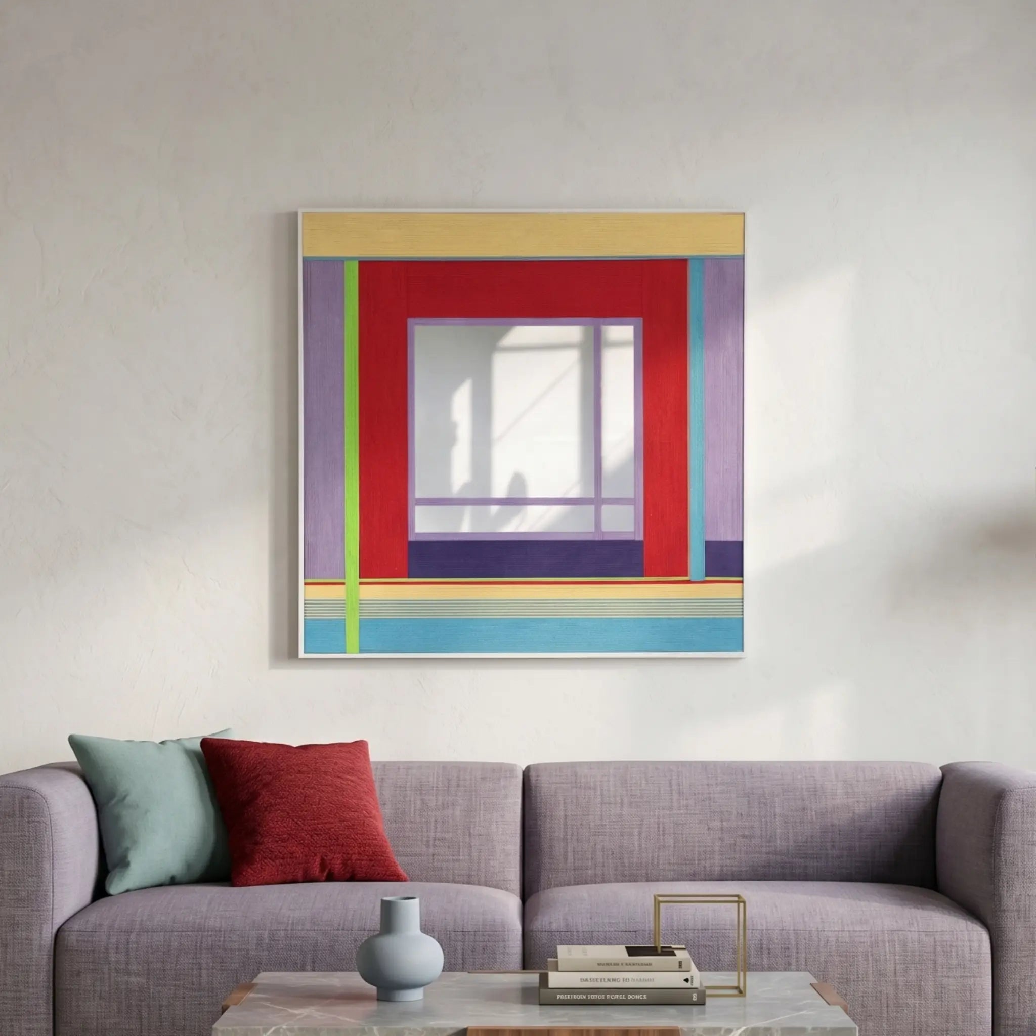 Large hand-woven wool wall art featuring red, purple, and blue geometric patterns hanging above a modern lavender sofa in a bright room.