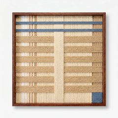 Frontal studio shot of the Breathing Shallows hand-woven wool wall art featuring beige, cream, and blue geometric patterns in a wooden frame against a clean white background.
