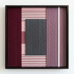 Professional studio shot of the Burgundy Overture hand-woven wool wall art in a square black frame against a clean white background.