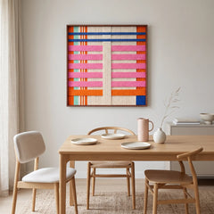 California Afterglow hand-woven wool tapestry styled as a stunning focal point above a wooden dining table in a contemporary dining room.