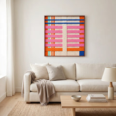Bright modern living room with the California Afterglow hand-woven wool tapestry hung elegantly as a centerpiece above a soft white sofa.