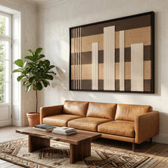 Striking hand-woven wool tapestry positioned perfectly above a stylish camel leather sofa in a sunlit living room with natural wood accents.