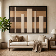 Large framed Canyon Whispers hand-woven wall art hanging elegantly above a cozy white sofa in a bright, modern living room setting.