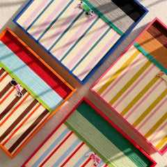 A creative layout showing multiple hand-woven wool wall art pieces from the collection, highlighting various colorful striped patterns and textures.