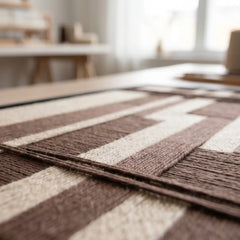 Extreme macro close-up of the Cocoa Grid hand-woven wool tapestry lying flat, highlighting the raised dimensional brown and cream textured yarn.