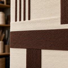 Detailed macro close-up of the Cocoa Horizon hand-woven wool tapestry highlighting thick brown and cream textured yarn.