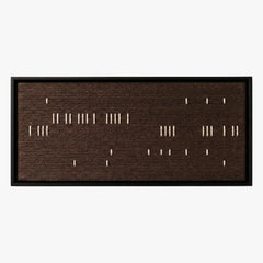 Frontal studio shot of the Cocoa Whispers hand-woven wool wall art featuring scattered white vertical stitches on a dark brown background in a black frame.
