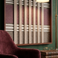 Angled close-up of the framed Dusty Tones hand-woven tapestry showcasing the wooden frame and dimensional mauve and cream wool patterns.