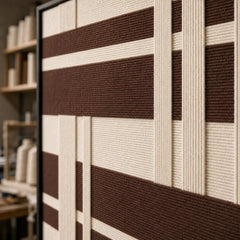 Detailed macro close-up of the Earthen Bands framed wall art highlighting the thick brown and cream hand-woven wool textures.