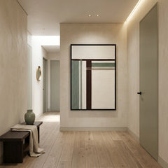 Vertical hand-woven wool wall art displayed at the end of a modern hallway, creating a sophisticated focal point in a minimalist home.