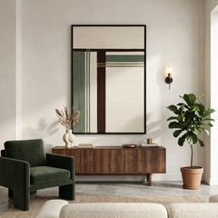 Wide interior view of a contemporary living space featuring the forest ruins wool tapestry styled with a dark green armchair and walnut furniture.