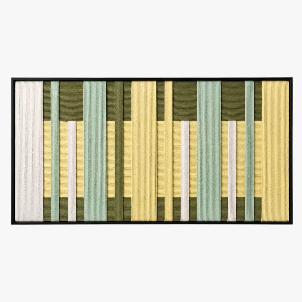 Frontal studio shot of the Garden Interval hand-woven wool wall art featuring green and yellow geometric patterns in a black frame.