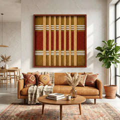 Striking square hand-woven wool tapestry positioned perfectly above a tan leather sofa in a bright, inviting living room with a patterned area rug.