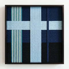 Frontal studio shot of the Glacial Stationeries wool wall art featuring a light blue cross pattern and striped accents in a black frame.